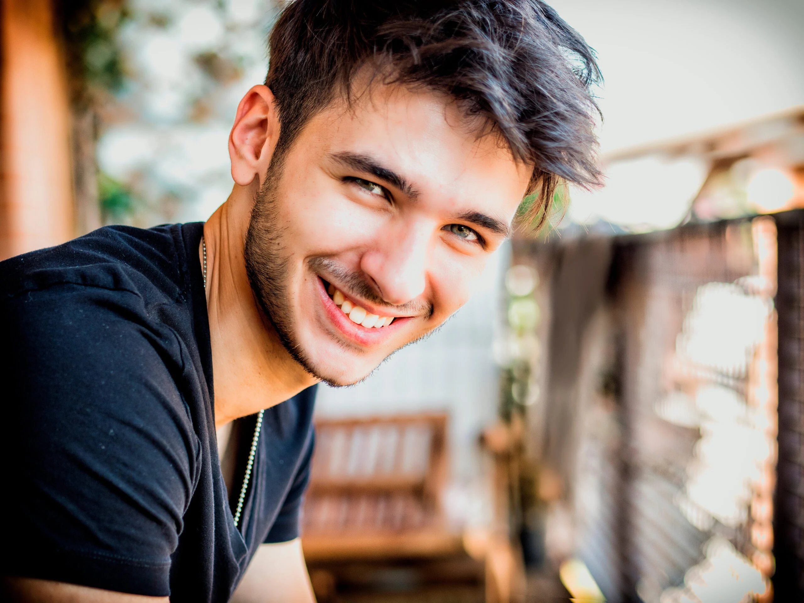 positive young man with a bright smile outdoors, symbolizing hope and well-being after a successful co-occurring disorder rehabilitation
