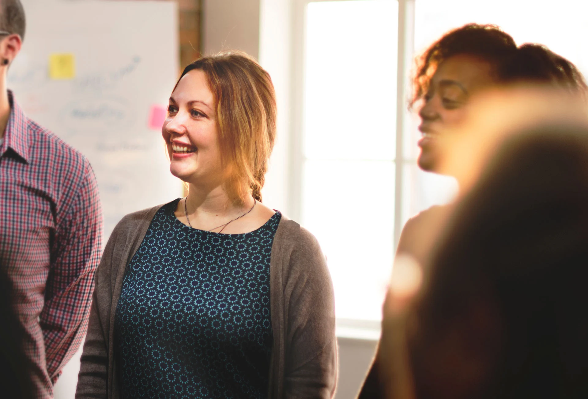 smiling people participating in group therapy, beneficial for addiction recovery support