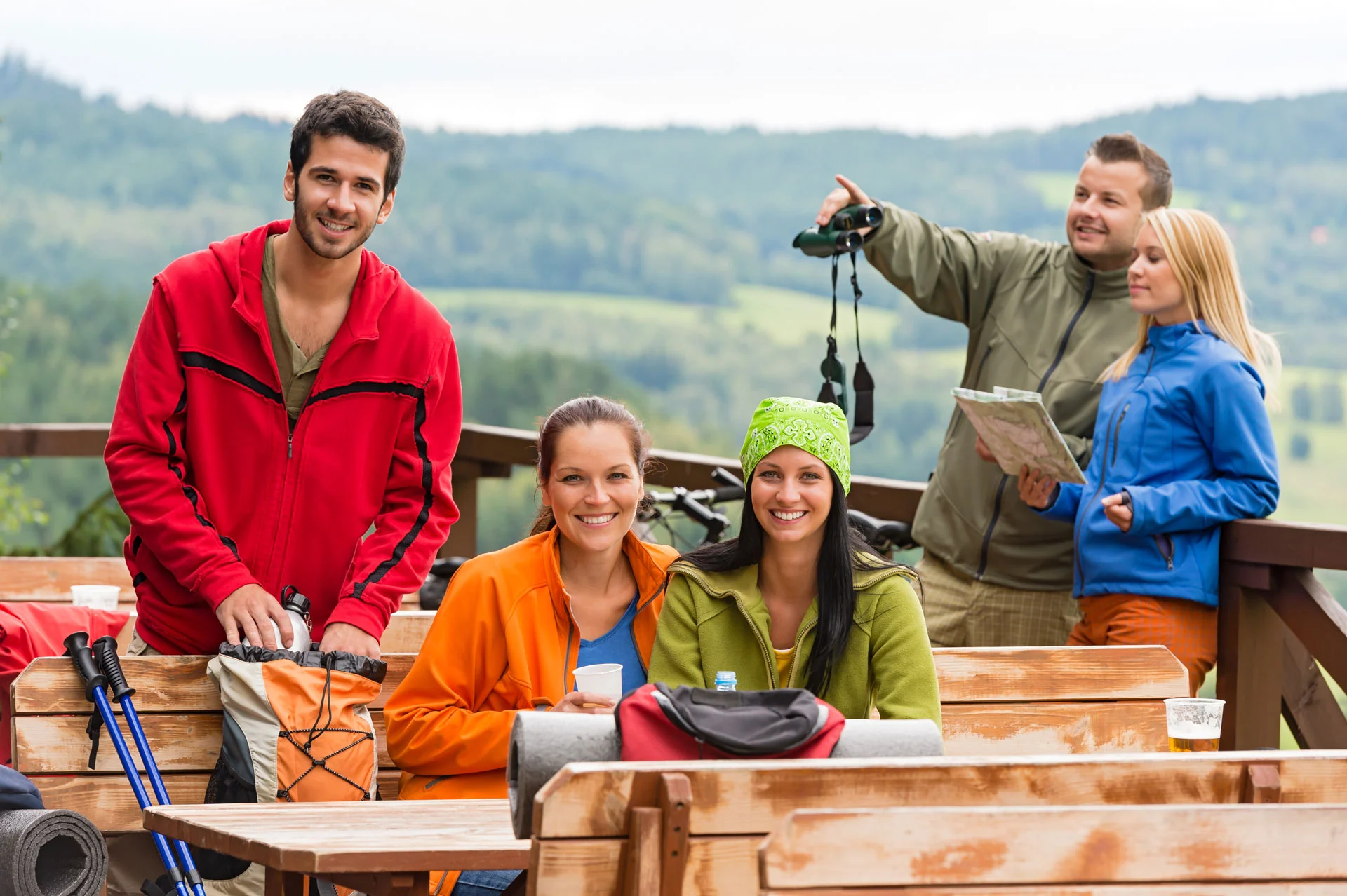 friends enjoying a break during a hike, possibly part of an outdoor program related to wellness and addiction recovery