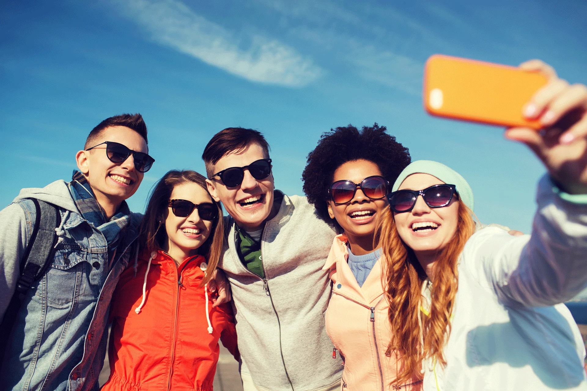 group of cheerful young friends taking a selfie, illustrating social connection and joy.