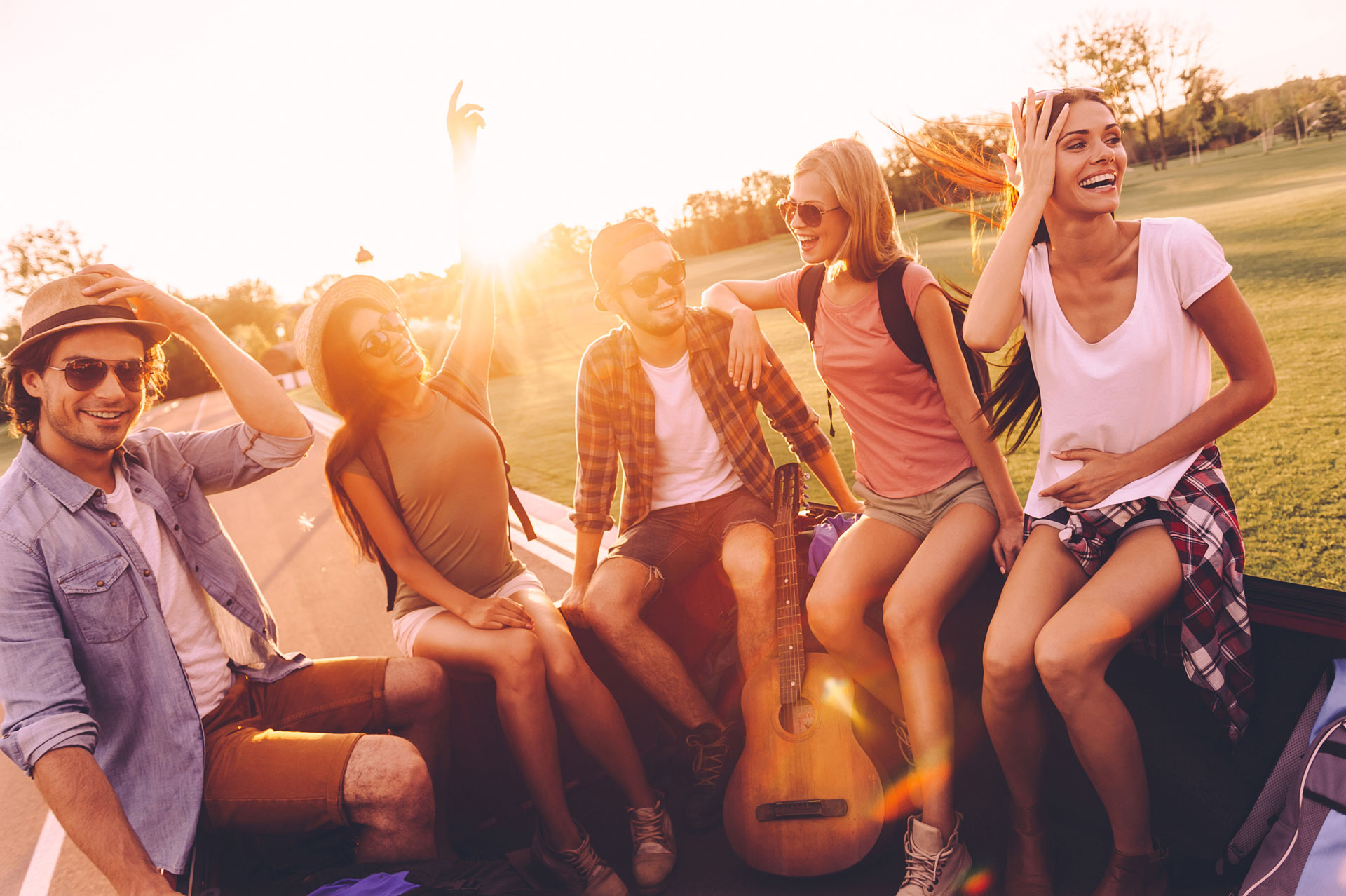 joyful friends on a road trip enjoying sunset, embodying friendship and leisure therapy.