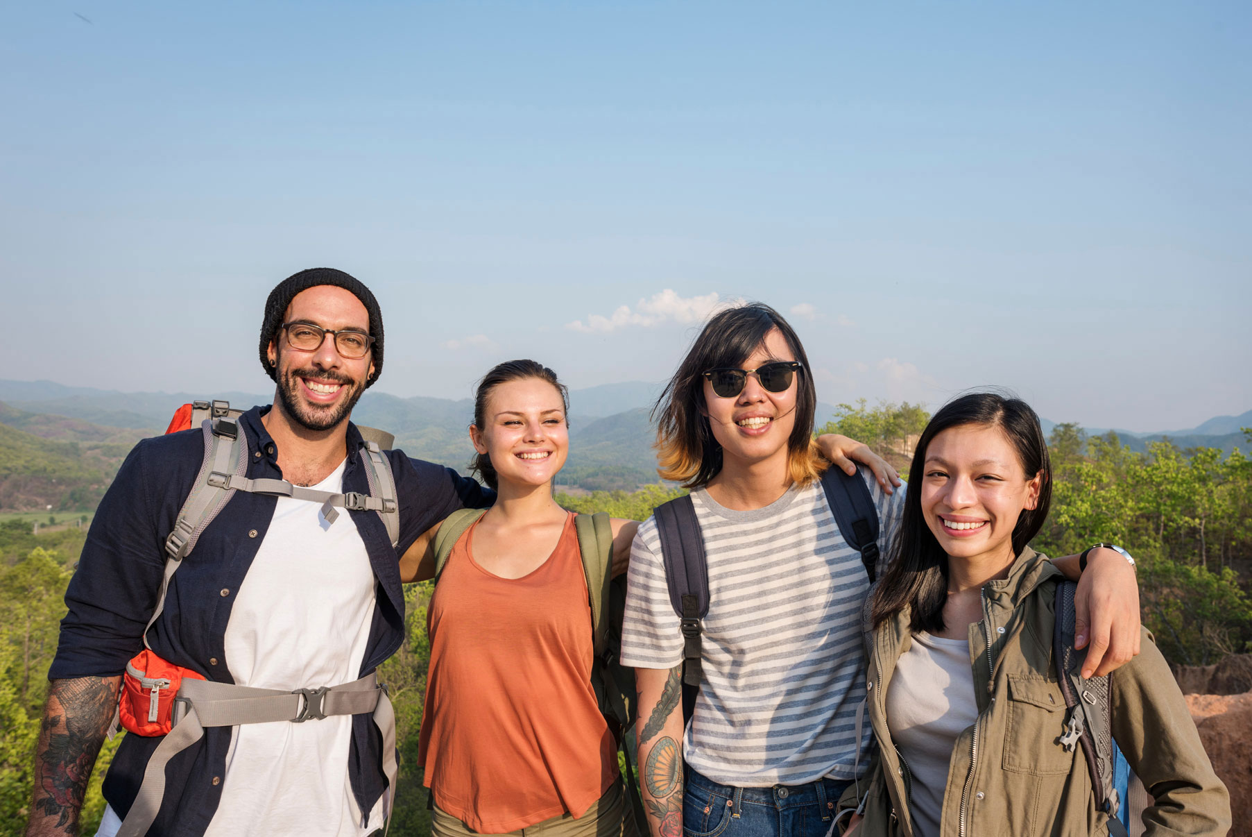 Group of happy friends hiking, symbolizing support in addiction recovery.