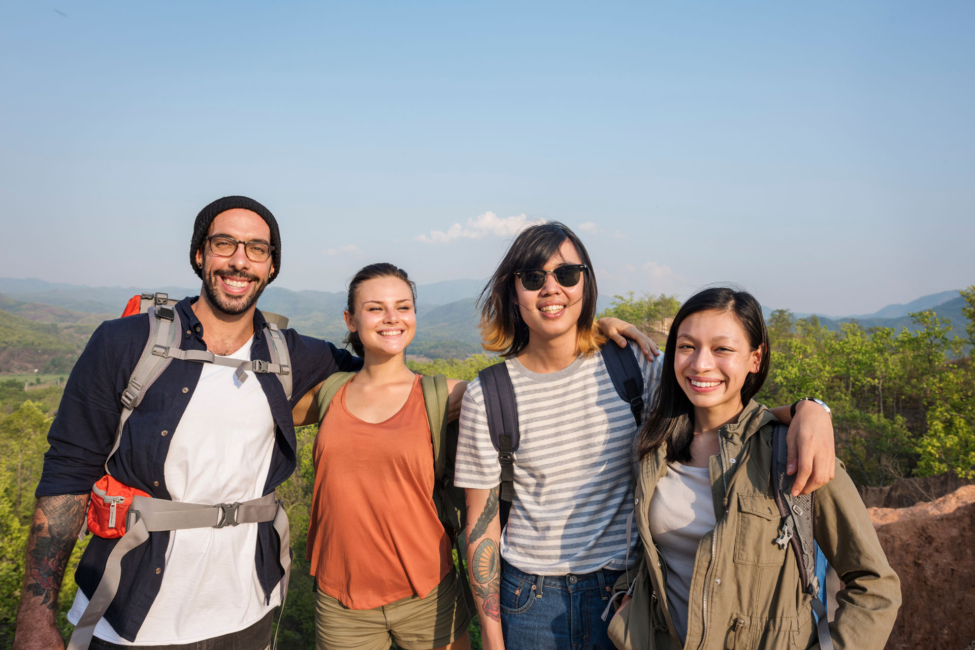 Group of happy friends hiking, symbolizing support in opioid addiction recovery.