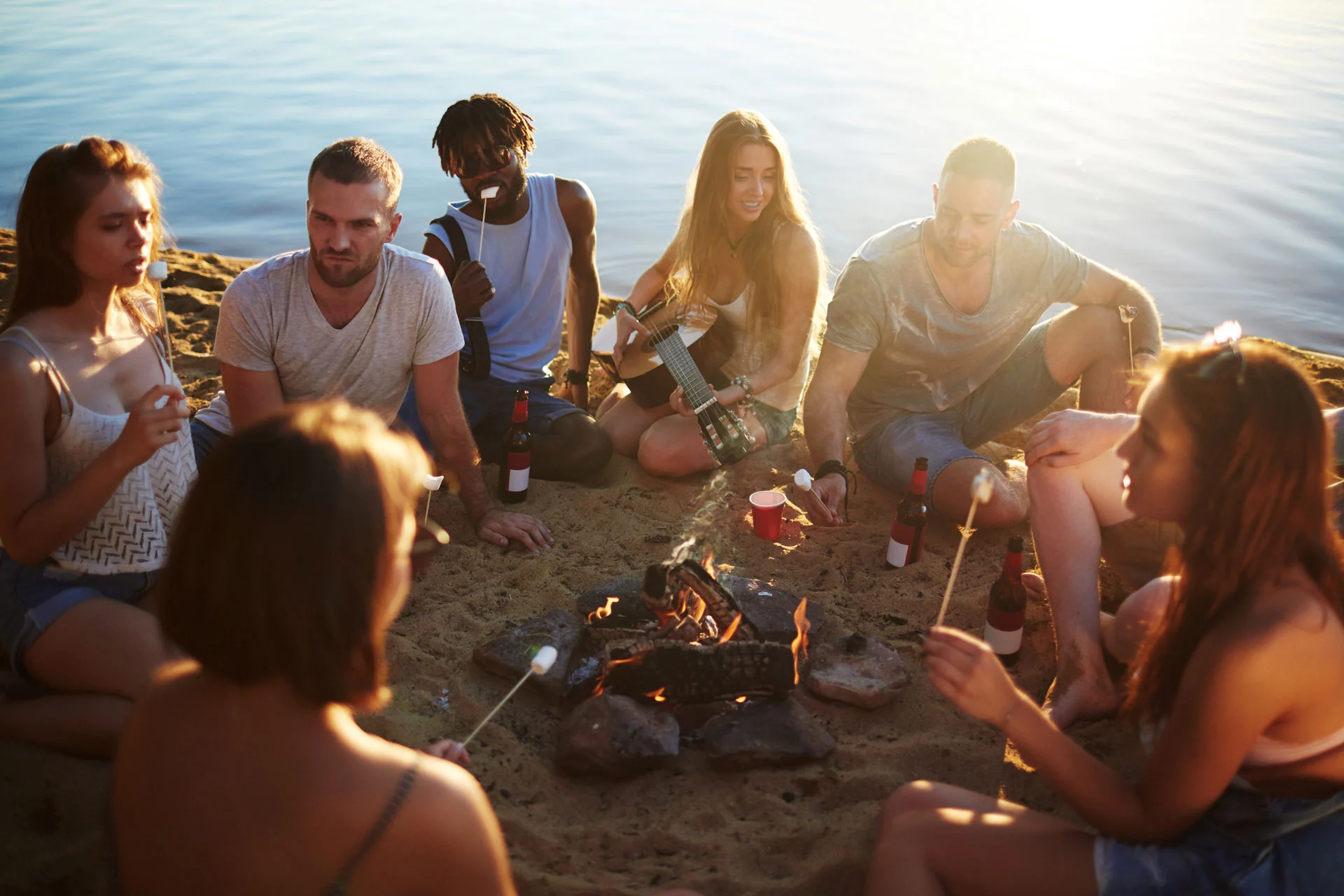 a group of friends having fun by the lake.