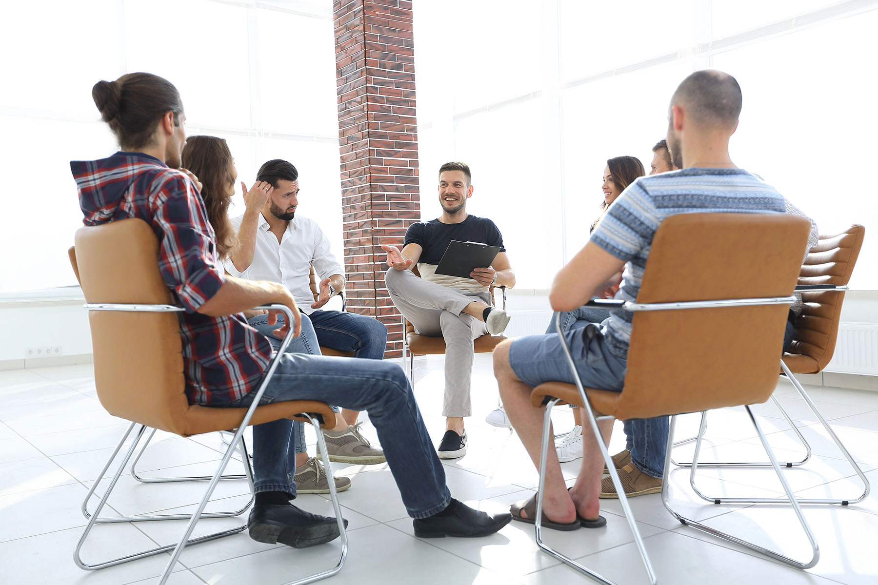 A Kratom addiction support group meeting with six people seated in a circle, discussing and offering support. A Kratom addiction support group meeting with six people seated in a circle, discussing and offering support.