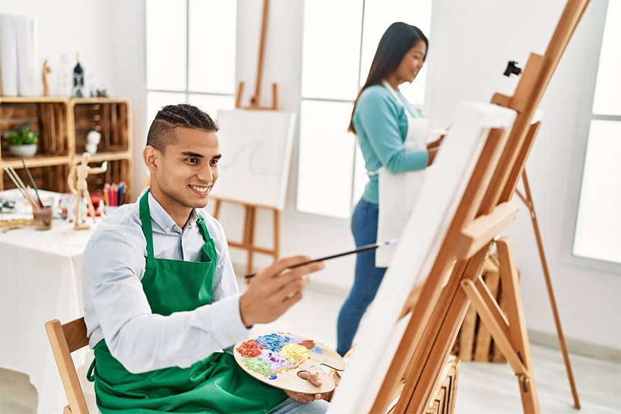 A Man And Woman Painting On Canvases In A Bright Studio During An Art Therapy For Addiction Session a man and woman painting on canvases in a bright studio during an art therapy for addiction session