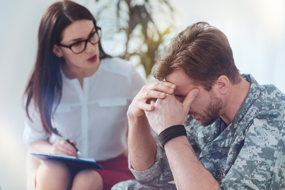 A veteran receiving one-on-one counseling from a therapist in a comfortable and professional setting illustrating TriWest for mental health treatment