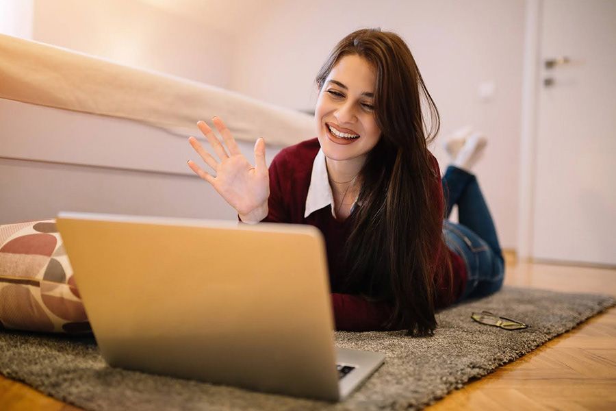 A Woman Waves At Her Laptop During A Virtual Iop For Opioid Drug Use Session From Home a woman waves at her laptop during a virtual iop for opioid drug use session from home