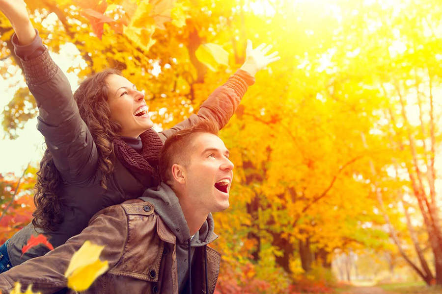 A young couple enjoying the autumn season. A young couple enjoying the autumn season.