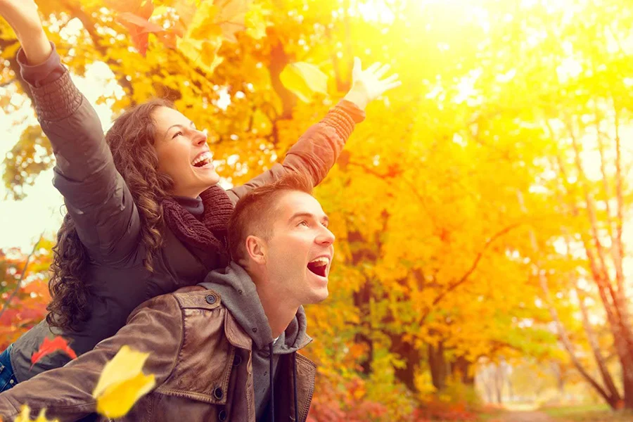 A Young Couple Enjoying The Autumn Season. a young couple enjoying the autumn season.
