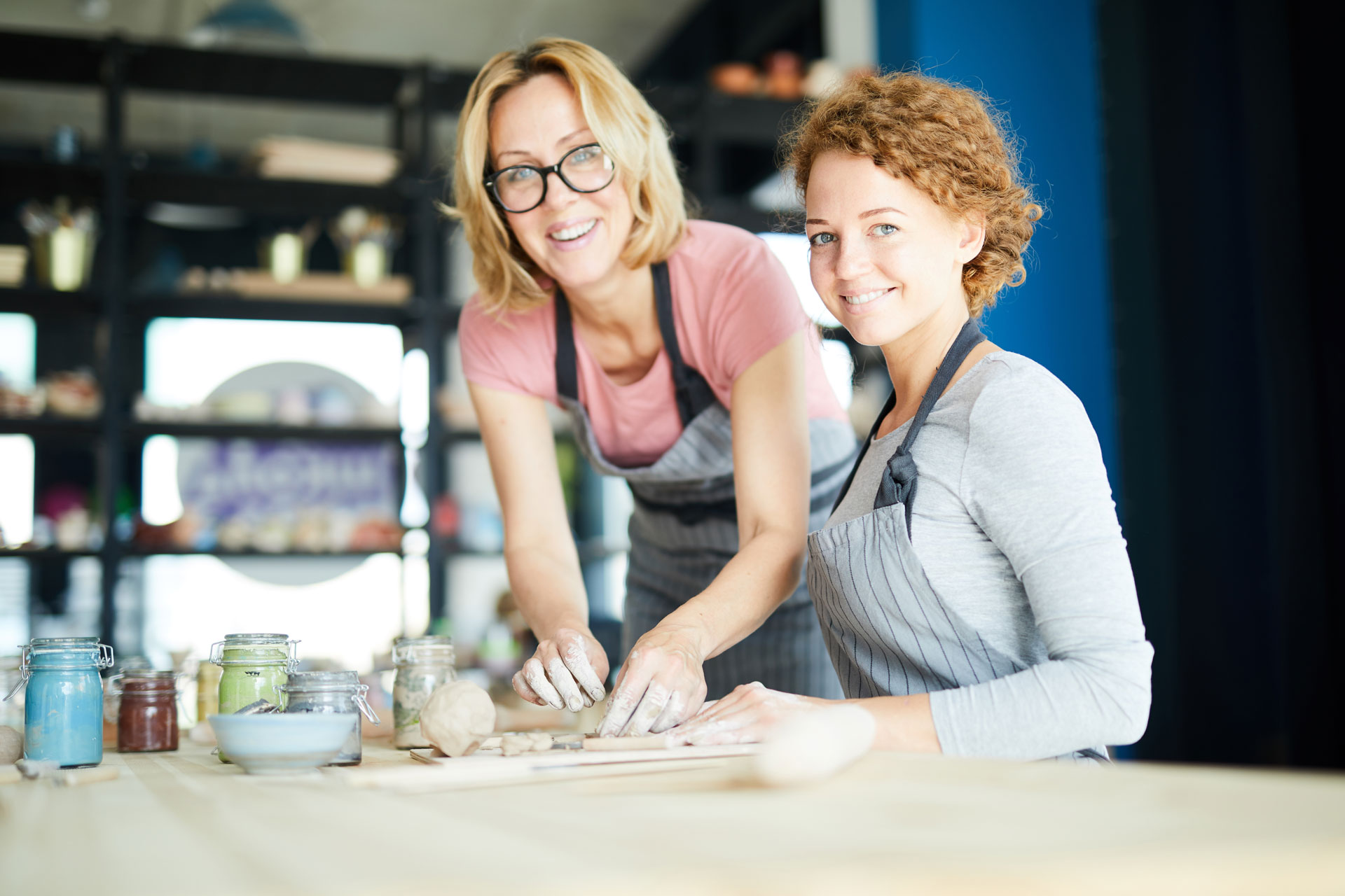Two women enjoying pottery, engaging in activities for emotional healing Two women enjoying pottery, engaging in activities for emotional healing
