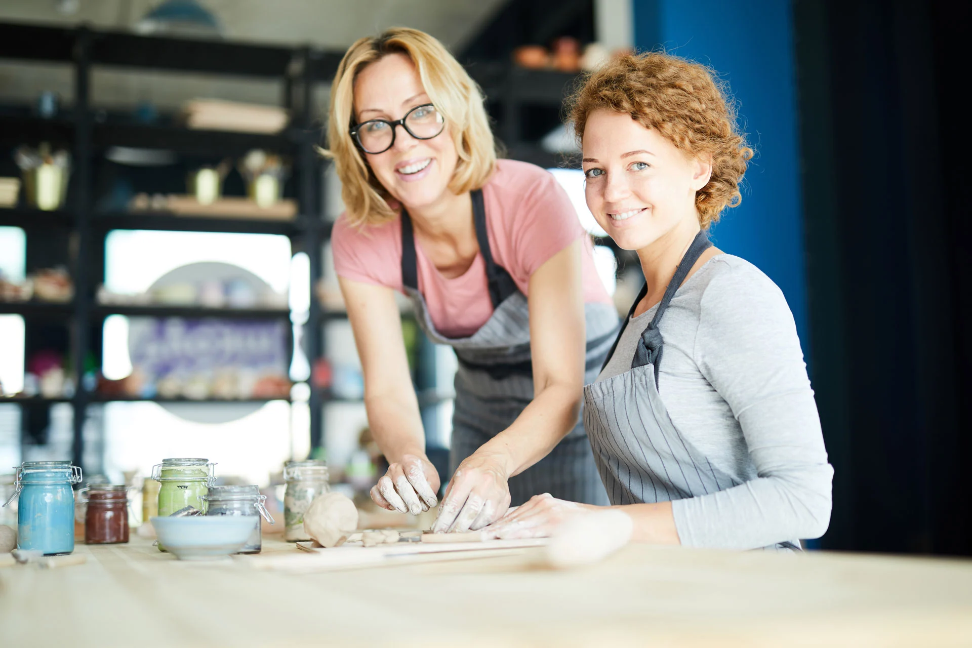 two women enjoying pottery, engaging in activities for emotional healing