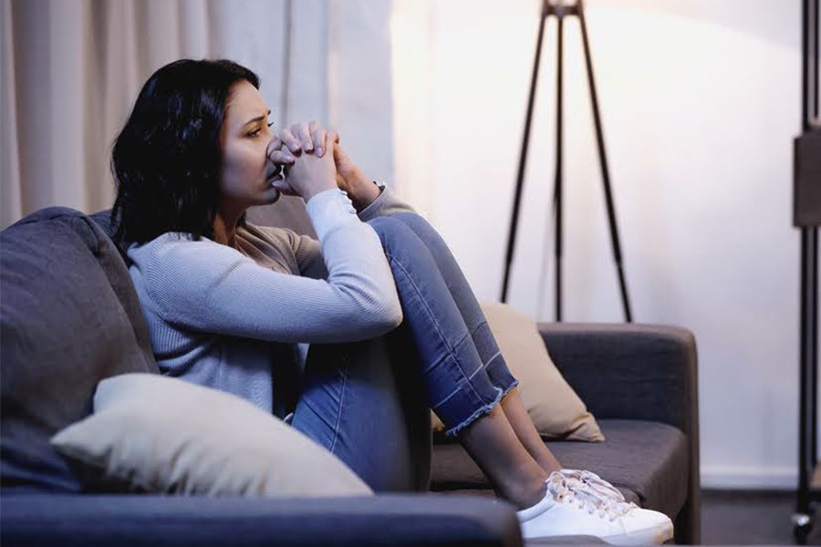 An image of a woman showing negative emotions and other trauma symptoms.