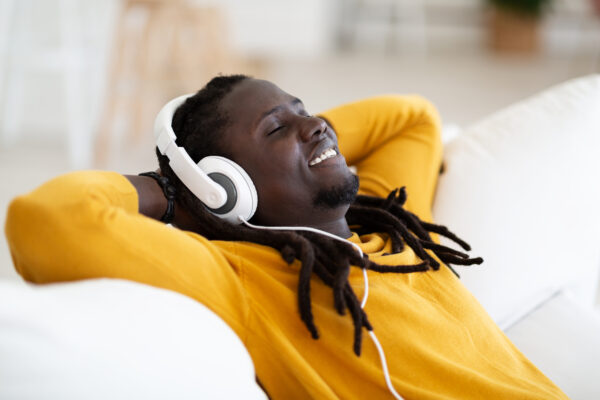 Close-up of a person listening to music during a music therapy session, fostering relaxation and personal reflection for stress relief and emotional healing