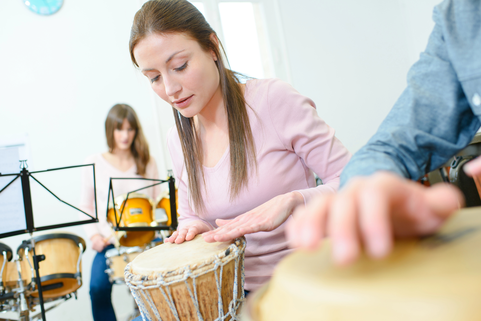closeup of a woman playing a drum helping to reduce anxiety and promote emotional healing