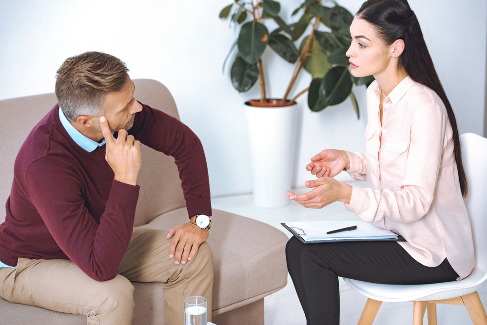 Counselor and man in a focused session, likely discussing treatment strategies for Benzo dependency Counselor and man in a focused session, likely discussing Benzo and its effects on the body's central nervous system
