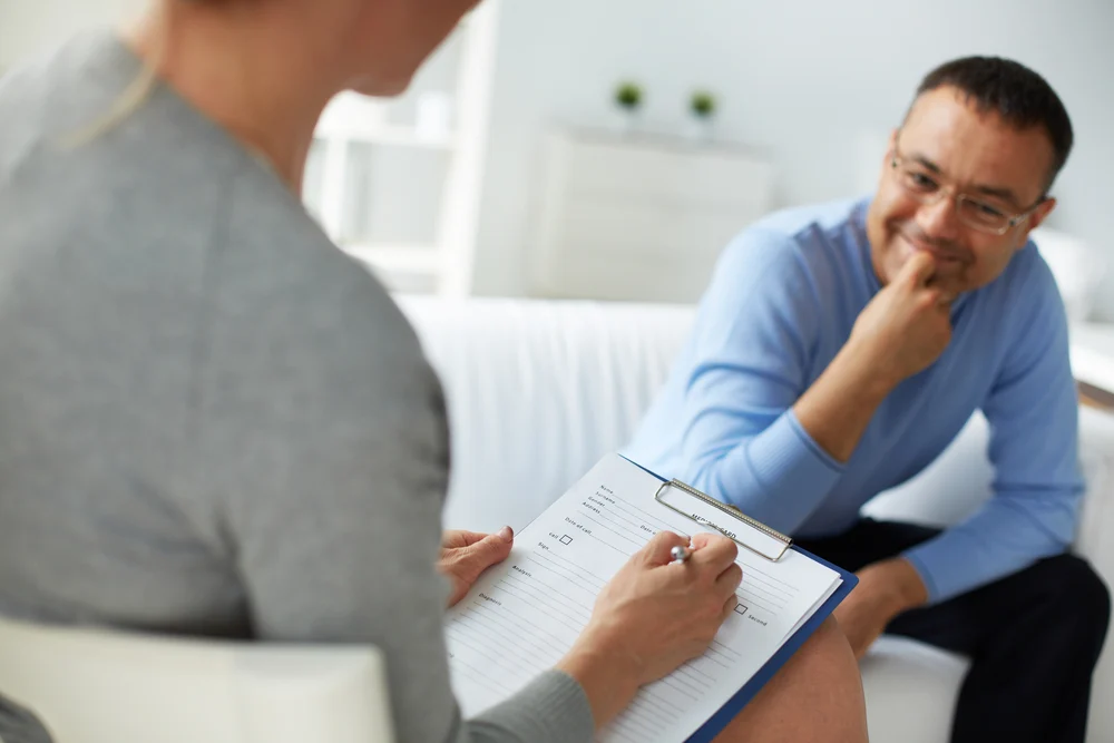 the therapist taking notes during a patient consultation for treating benzodiazepine addiction