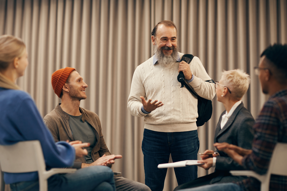 Group participating in a supportive PTSD therapy session with guidance from a therapist Group participating in a supportive PTSD therapy session with guidance from a therapist
