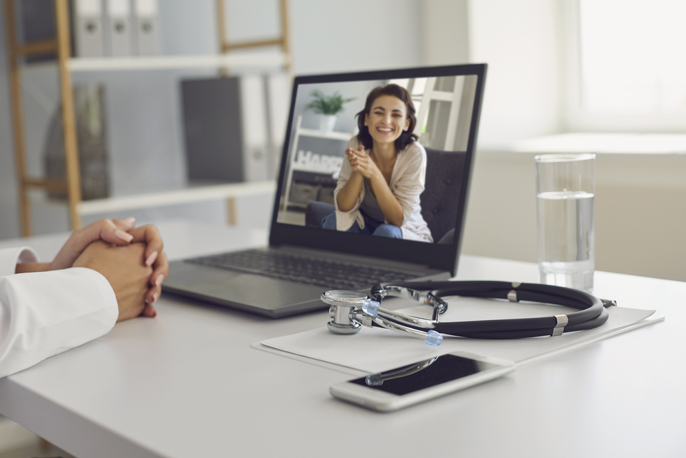 Online doctor services. Online medical consultation concept. Individual in a virtual counseling meeting using a laptop, receiving remote mental health support