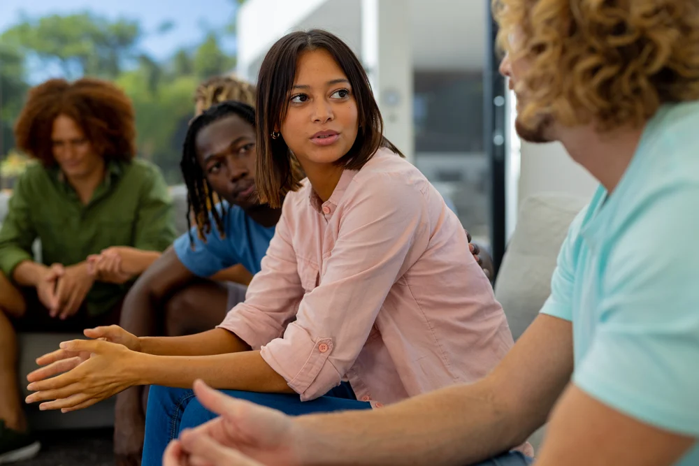 woman speaking at a group therapy meeting with a caring atmosphere