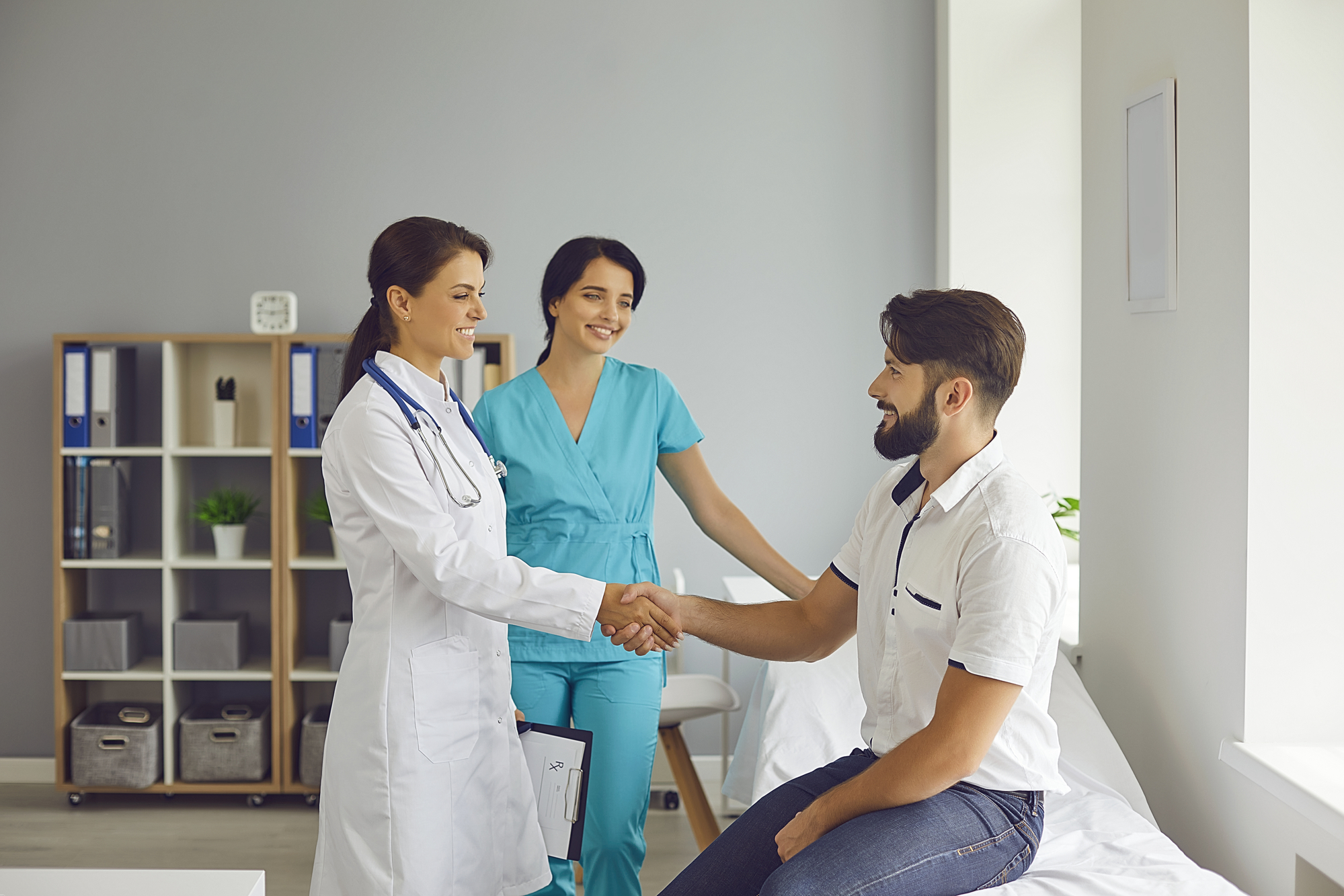 Doctor and nurse shaking hands with a patient, symbolizing accessible mental health services through Medicaid