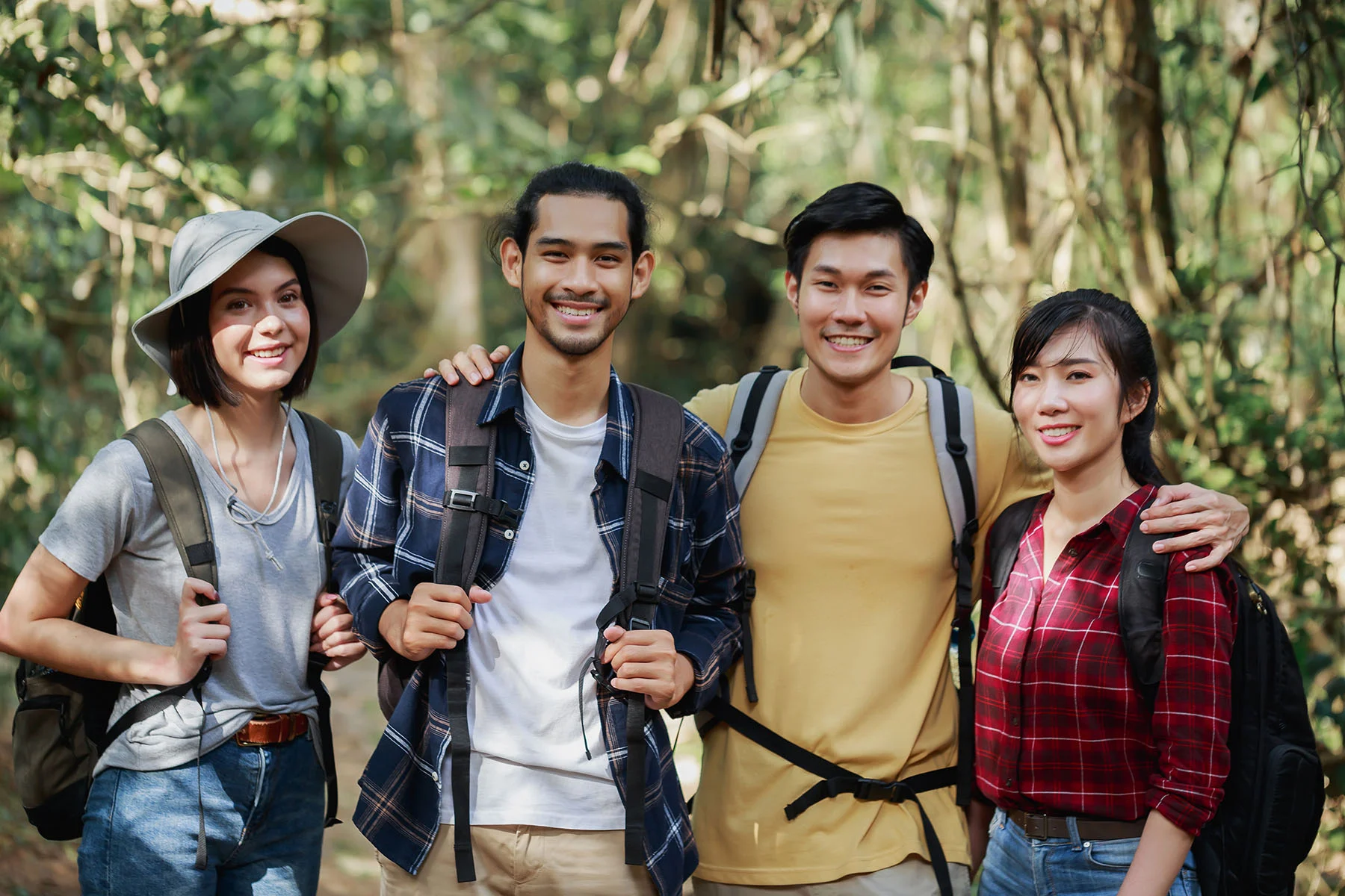 group of young friends posing together during a hike as part of their therapeutic outdoor activity for kratom addiction