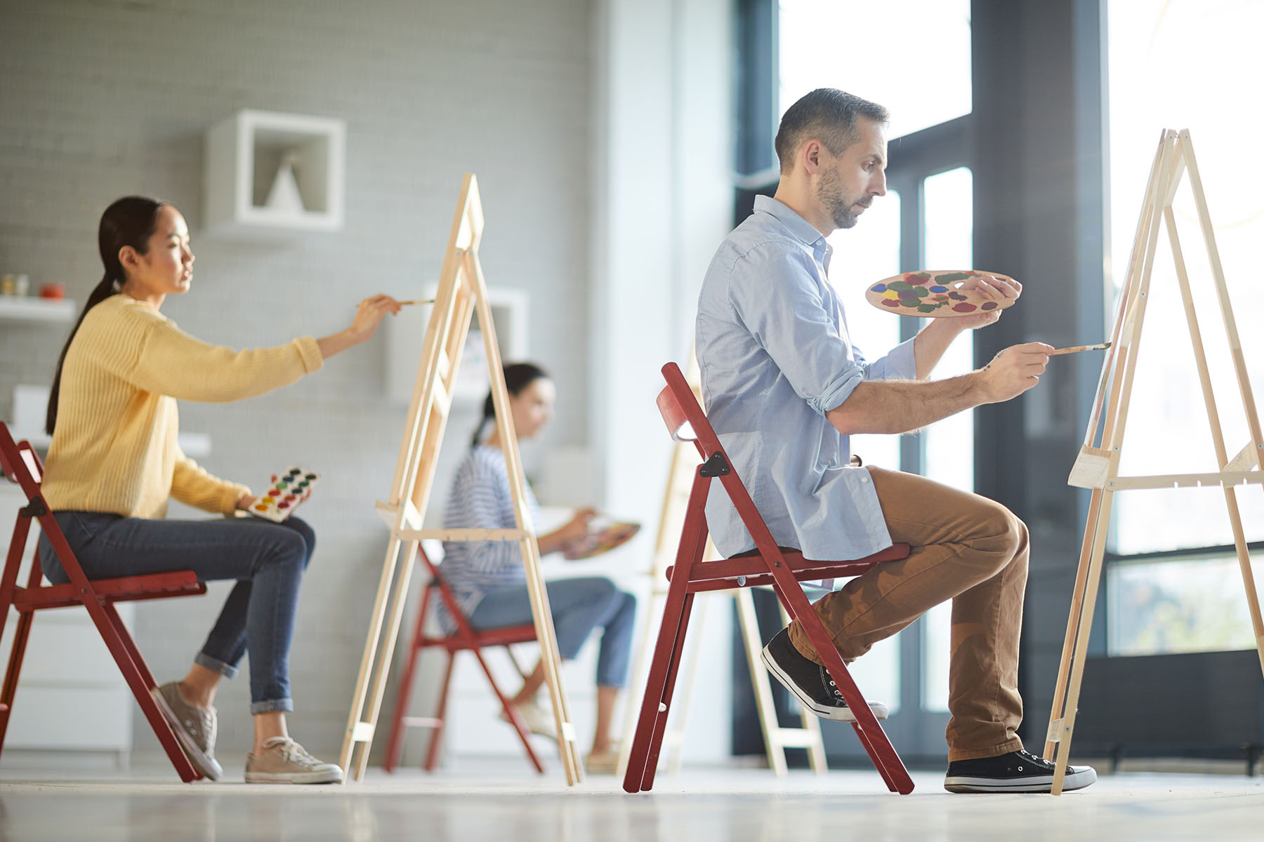 People engaging in a painting class as part of a program for overcoming kratom dependence through art therapy Art therapy session in progress, potentially for substance recovery programs