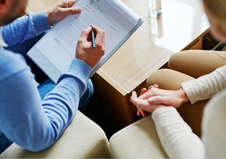 A person filling out a form during a session, likely related to recovery services for alcohol addiction therapy A person filling out a form during a session, likely related to recovery services for alcohol addiction therapy