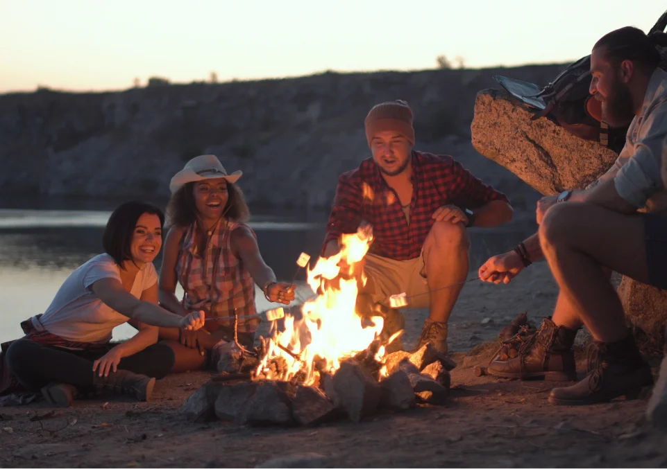 friends roasting marshmallows and enjoying a fireside chat at a therapeutic outdoor retreat