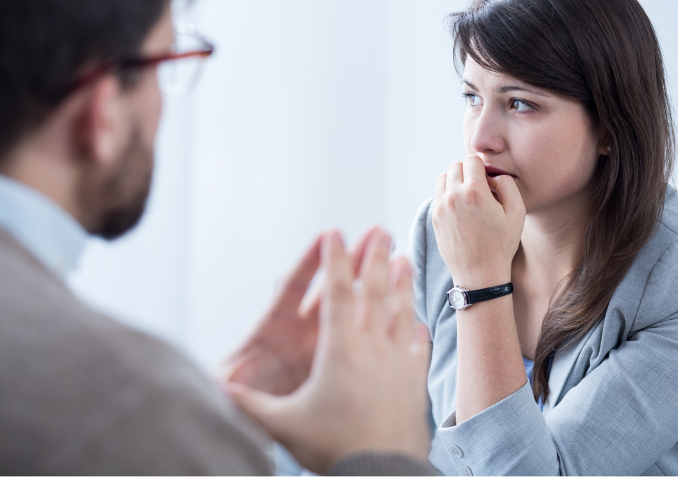 Concerned woman in consultation, indicative of engaging in recovery therapy from alcohol addiction Concerned woman in consultation, indicative of engaging in recovery therapy to treat alcohol dependence