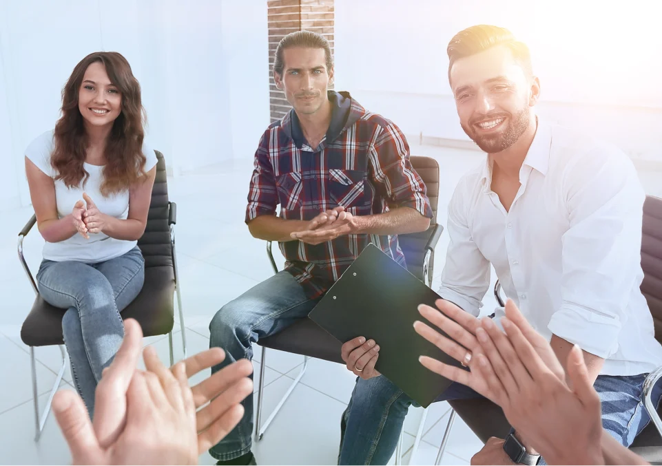 participants in a group therapy session likely focused on alcohol misuse recovery and support