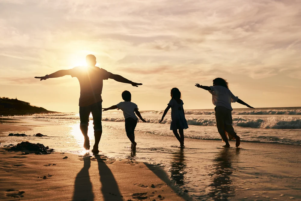 signs of drug addiction featured image - silhouette, family is running on beach and back view with ocean waves, sunset and bonding in nature.