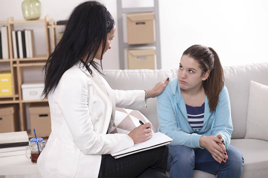 Teen Speaking With A Therapist During An In-Person Counseling Session, Showing Supportive Mental Health Services In A Calm Setting teen speaking with a therapist during an in-person counseling session, showing supportive mental health services in a calm setting