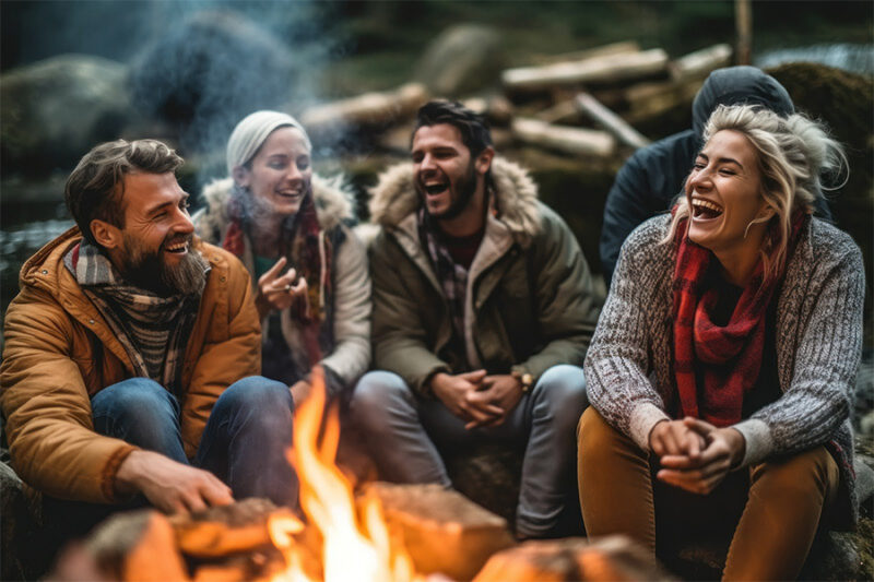 Trauma survivors embrace the healing power of the wilderness, sharing smiles and camaraderie around a campfire. Trauma survivors embrace the healing power of the wilderness, sharing smiles and camaraderie around a campfire.