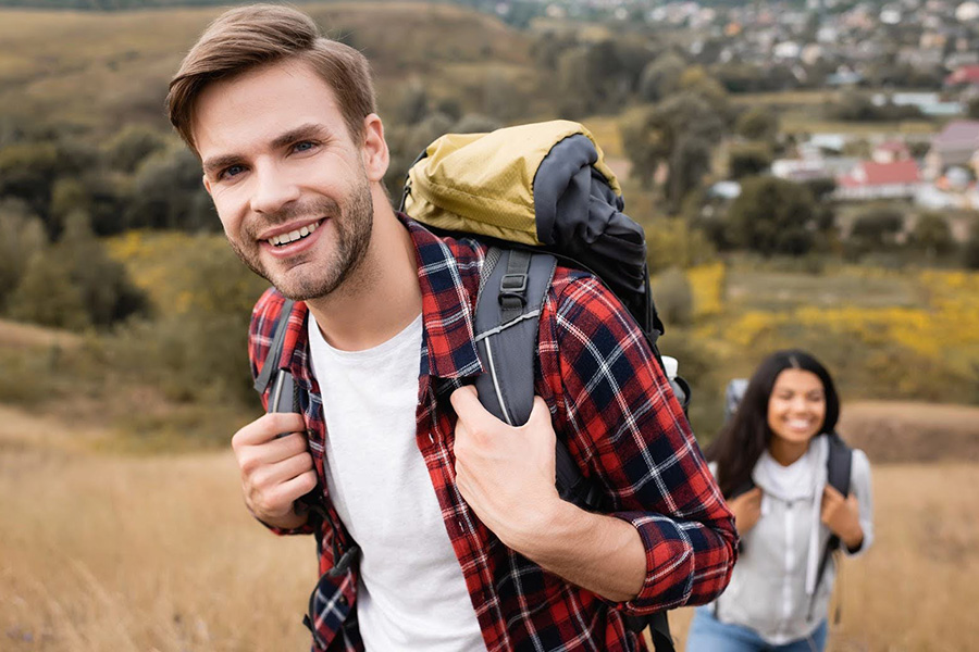 Two People Smiling While Hiking, Showing A Healthy Lifestyle During Recovery From Opioid Addiction two people smiling while hiking, showing a healthy lifestyle during recovery from opioid addiction