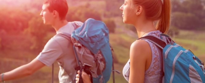 two teens hiking with backpacks outdoors, illustrating therapy for teens through nature-based support and growth