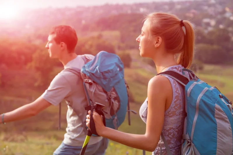 Two Teens Hiking With Backpacks Outdoors, Illustrating Therapy For Teens Through Nature-Based Support And Growth two teens hiking with backpacks outdoors, illustrating therapy for teens through nature-based support and growth