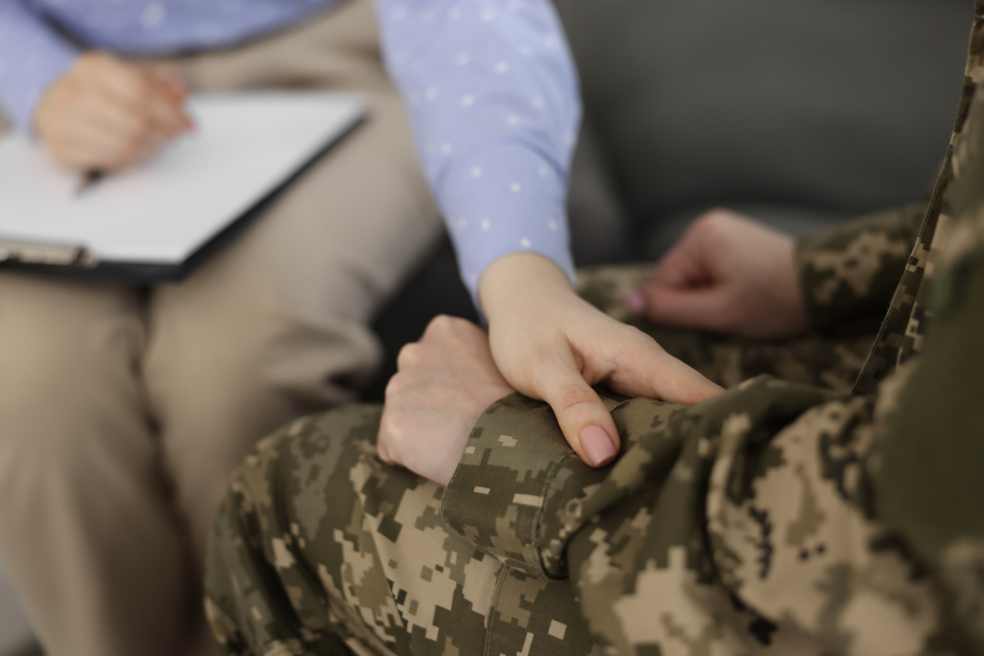 Veteran discussing addiction treatment options with a healthcare provider in a supportive environment illustrating TriWest for addiction treatment