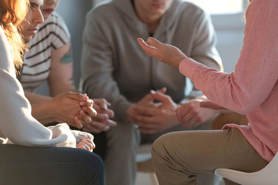 Veterans participating in a group therapy session, fostering community and support for addiction recovery.