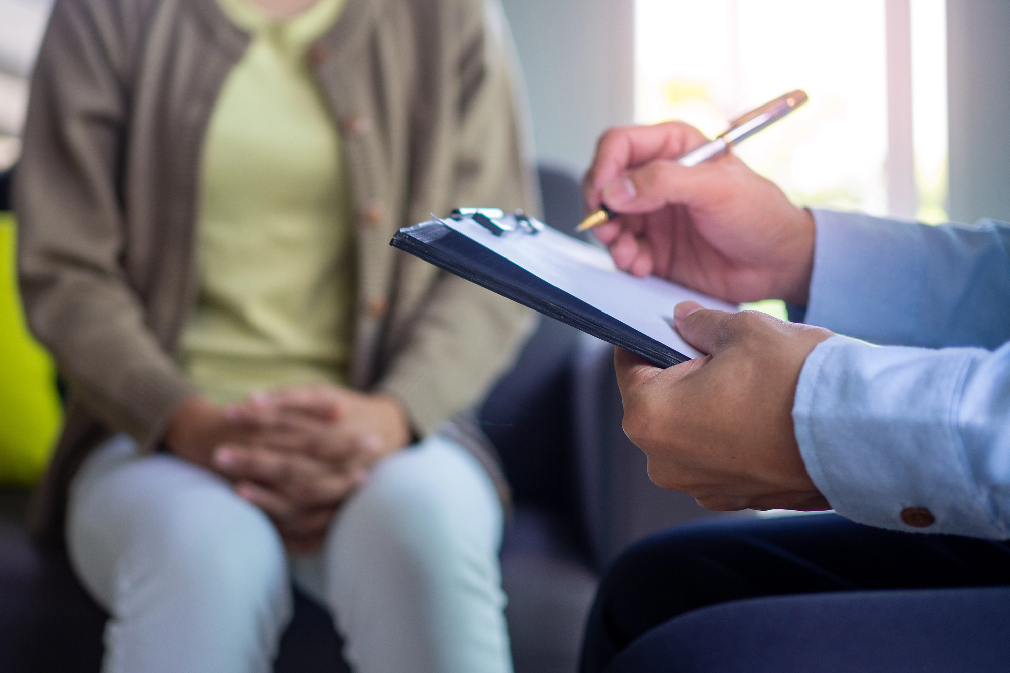 Female client having consultation with psychologist, grateful for professional help and her BCBSMT mental health coverage.