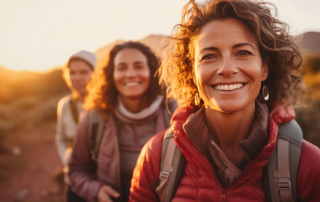 joyful hikers with backpacks in golden hour sunlight on a group outdoor journey
