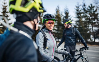 cyclists with helmets sharing a joyful moment on a therapeutic biking trail