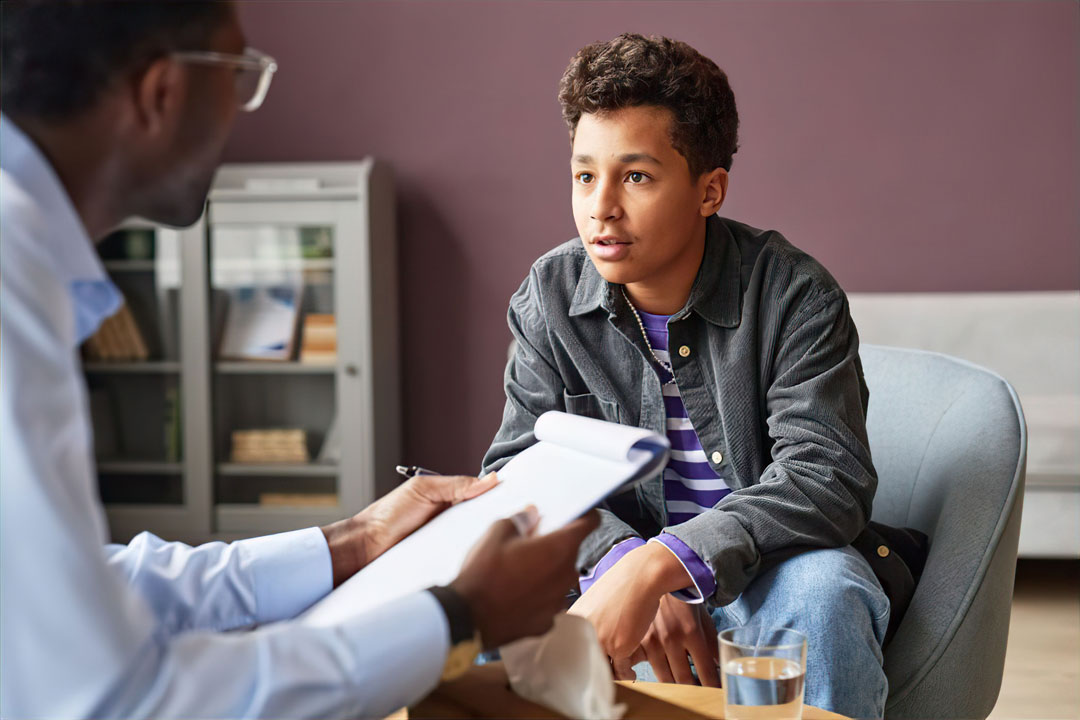 Teen in consultation for adolescent addiction recovery with a counselor