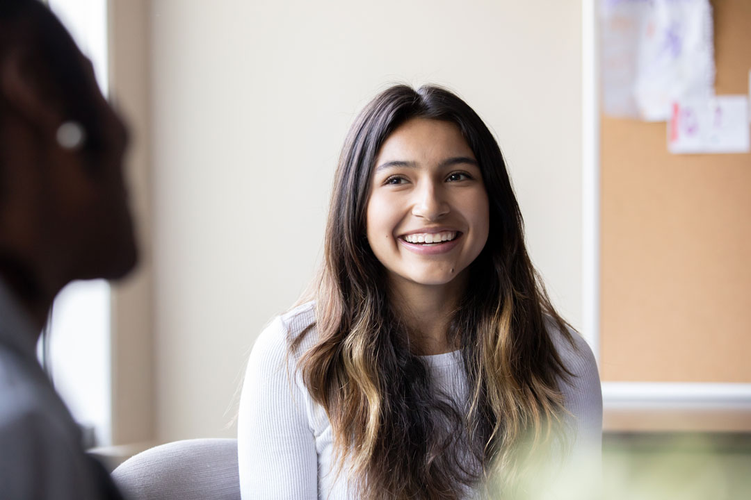 Smiling girl in a therapy session for dual diagnosis treatment youth