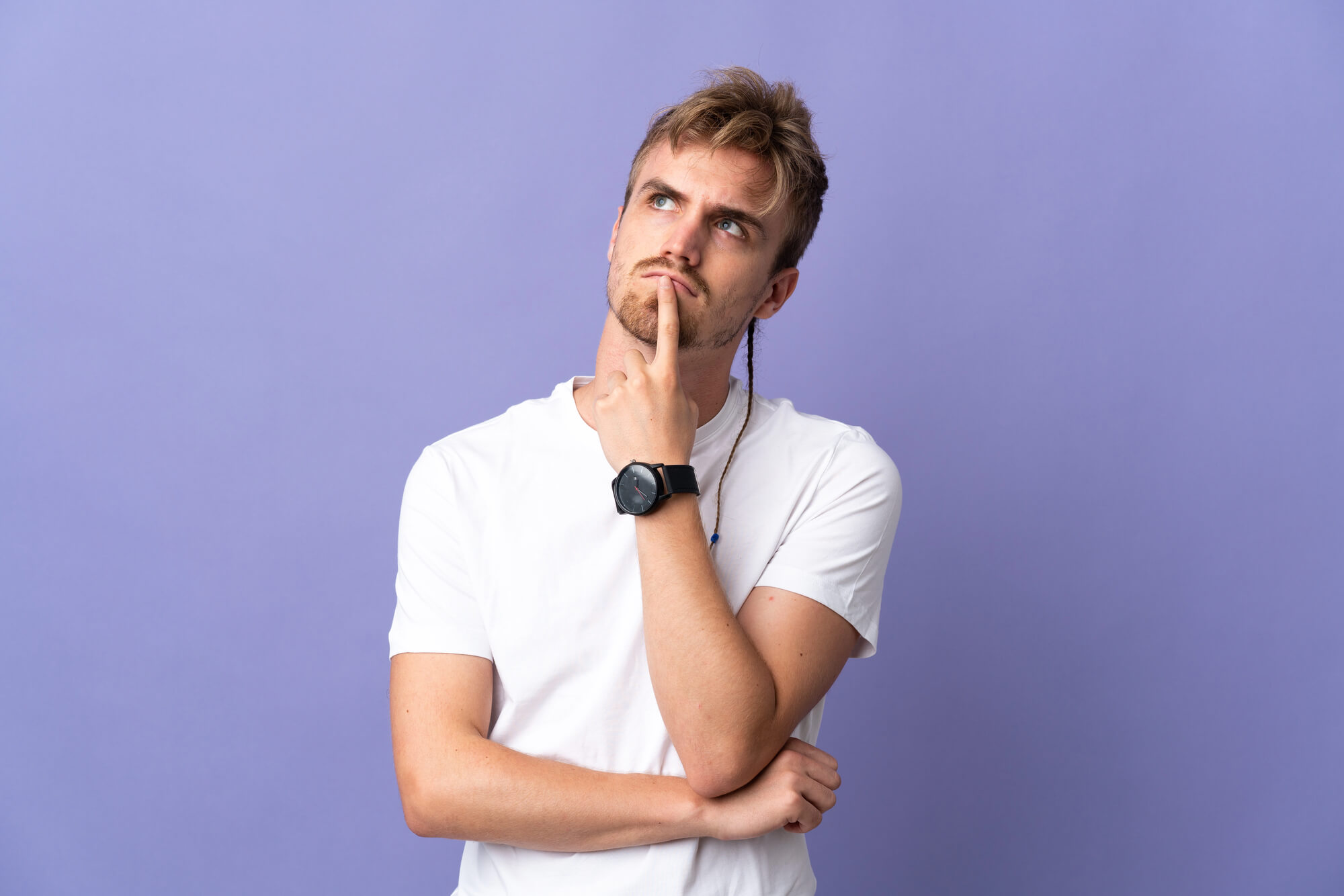 man contemplating A Kratom addiction support group meeting with six people seated in a circle, discussing and offering support.