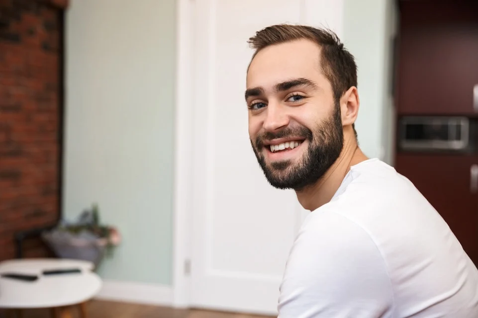 smiling man in a modern kitchen reflecting the welcoming environment at big sky treatment