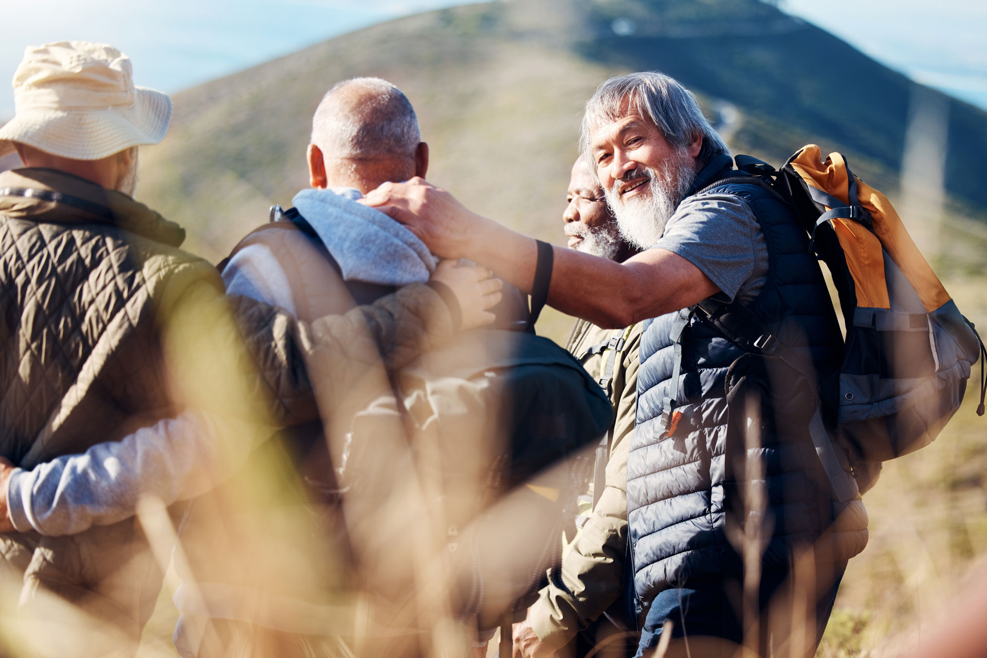Senior hikers supporting each other, part of Adult Recovery Services with outdoor activities