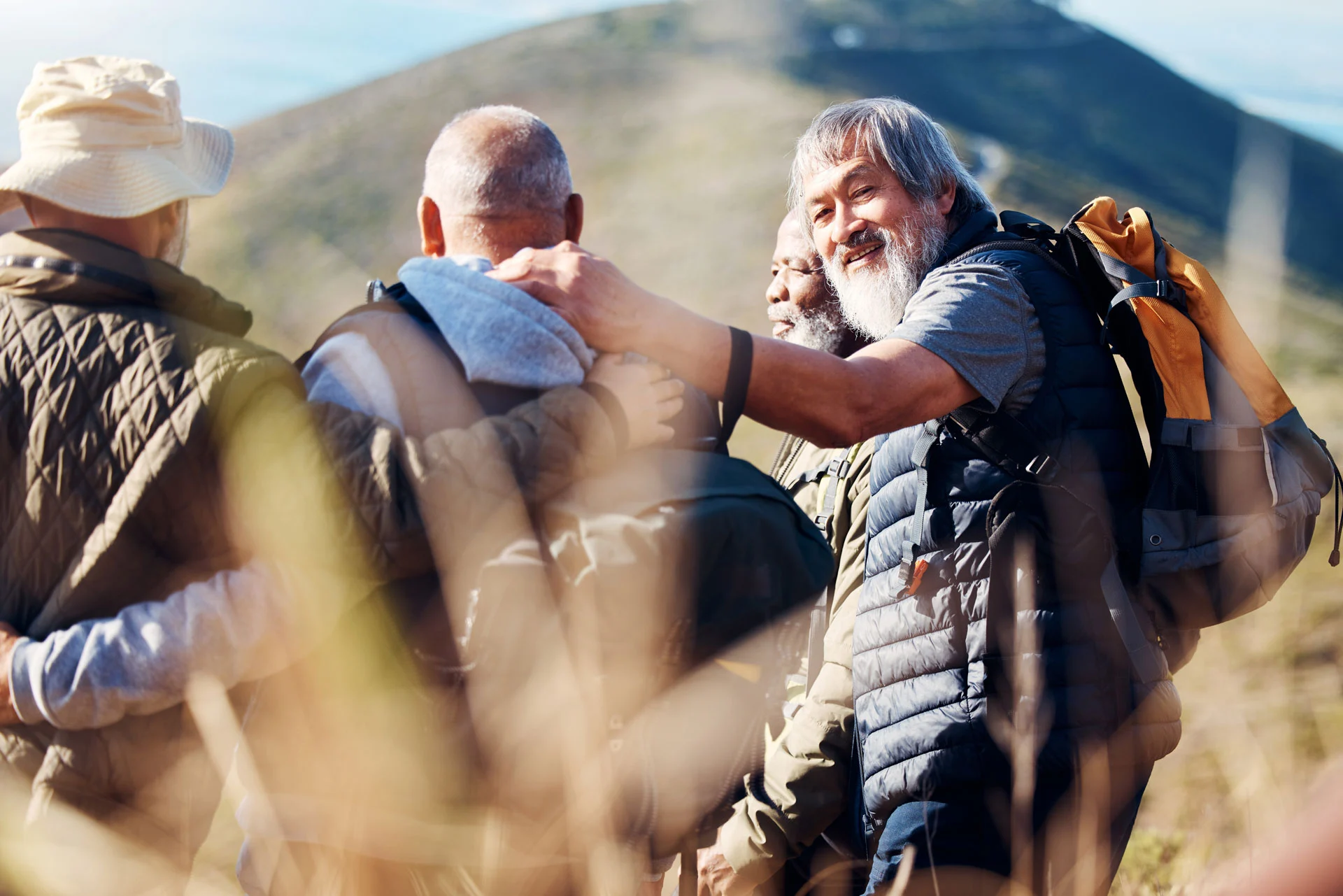 senior hikers supporting each other, part of adult recovery services with outdoor activities