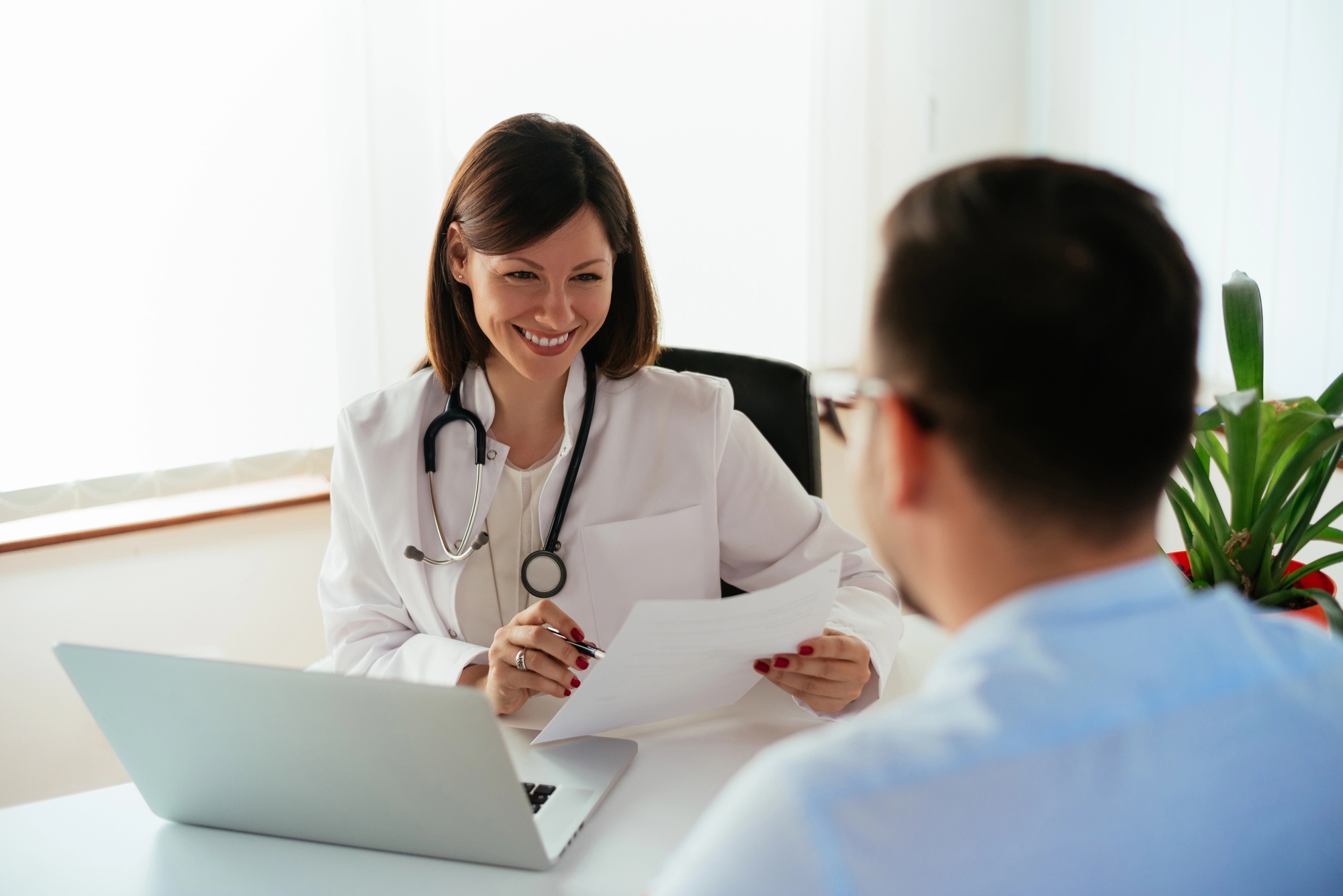 Doctor talking with a patient, symbolizing accessible mental health services through BCBSMT