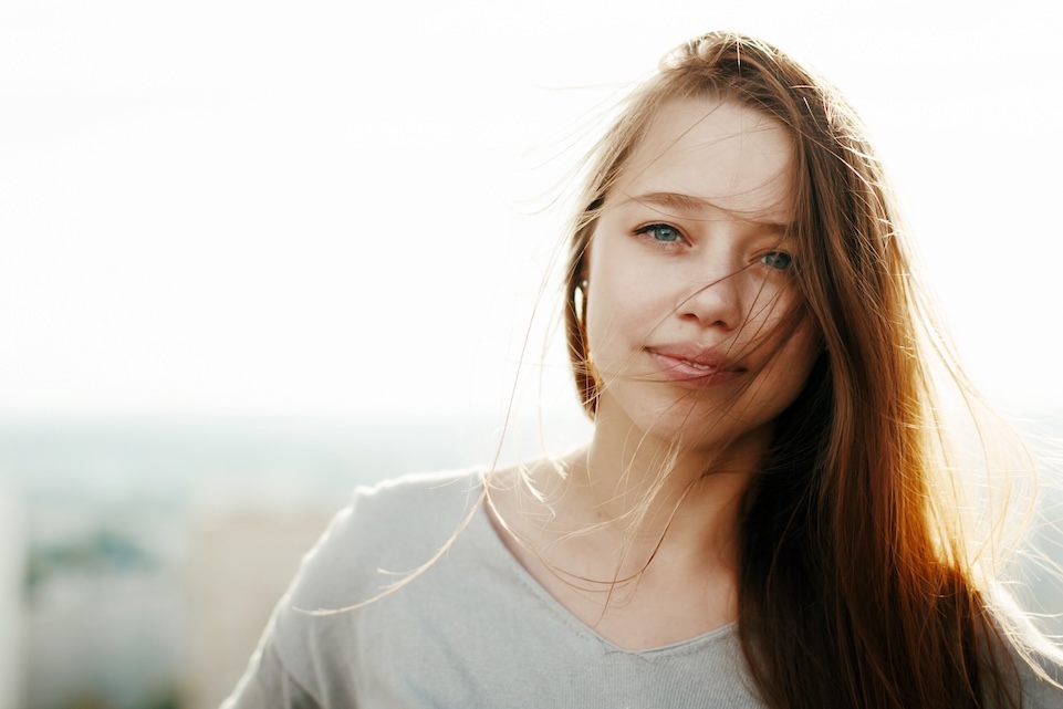 Young stylish woman in the sunlight Serene young woman in sunlight symbolizing hope and healing in recovery from addiction